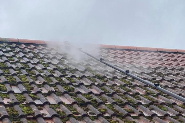 Jet washing moss on roof
